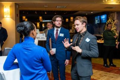 Students talking to an employer at the networking mixer 在竞技宝app下载